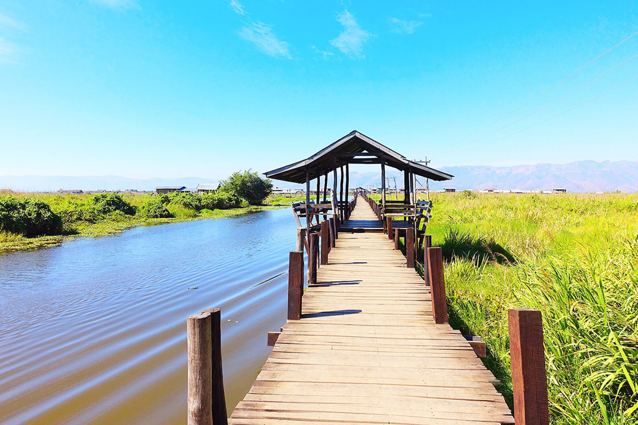The wooden bridge connects the land at Maing Thauk to the floating village
